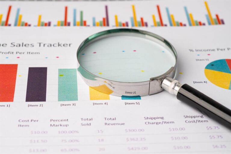 magnifying glass on charts graphs paper 2026 01 08 06 56 30 utc
